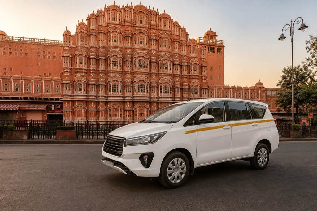 White Jangid taxi in front of Hawa Mahal, Jaipur